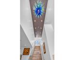 Stairway with Chihuly fixture view 2